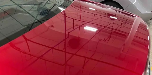 After paint correction — same red vehicle panel with restored gloss and clarity at Studio One Protection in Tri-Cities, WA.