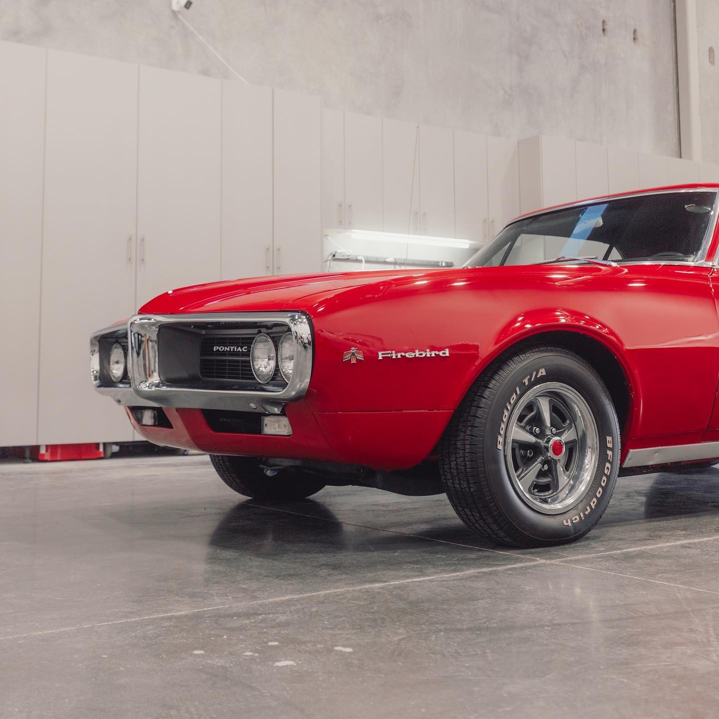 Red Pontiac Firebird in the Studio One Protection studio in Tri-Cities, WA — new vehicle intake before paint protection and ceramic coating.